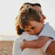 Image of a parent comforting a toddler