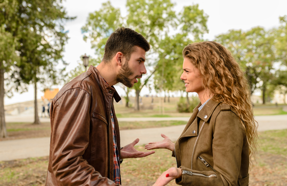 couple trying to talk in park