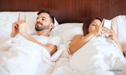 ADHD Couples: Solutions Beyond Traditional Therapy 15 distracted couple in bed