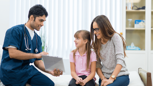 doctor explaining to kid and mom