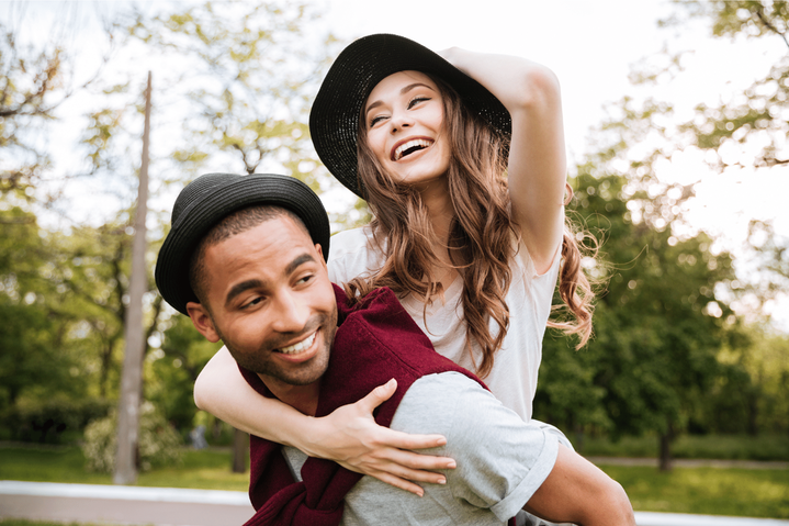 Happy couple giving each other a piggyback